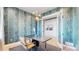 Home office with stylish wallpaper and built-in shelving at 1781 Chestnut Ave, Erie, CO 80516