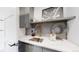 Stylish wet bar with a quartz countertop, hexagon tile backsplash, and a gold faucet at 1781 Chestnut Ave, Erie, CO 80516