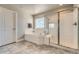 Bright bathroom featuring a soaking tub, and walk-in shower at 9574 Keystone Trl, Parker, CO 80134