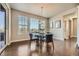 Elegant dining area with a modern chandelier and a view of the outdoors through large windows at 9574 Keystone Trl, Parker, CO 80134