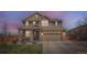 Charming two-story home with a covered porch, stone accents, and a well-manicured lawn at 9574 Keystone Trl, Parker, CO 80134