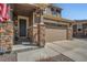 Close up of the front entrance showcasing stone pillar accents and a modern two car garage at 9574 Keystone Trl, Parker, CO 80134