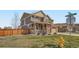 Charming two-story home with a welcoming front porch, landscaped yard, and a well-manicured lawn at 9574 Keystone Trl, Parker, CO 80134