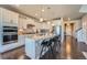 Bright, modern kitchen with stainless steel appliances and an eat-in island with barstool seating at 9574 Keystone Trl, Parker, CO 80134
