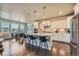 Bright, modern kitchen with stainless steel appliances and an eat-in island connecting to a dining area at 9574 Keystone Trl, Parker, CO 80134