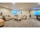 Inviting living room with a large sectional sofa, plush carpet, and ample space for relaxation at 9574 Keystone Trl, Parker, CO 80134