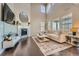 Spacious living room featuring high ceilings, large windows, hardwood floors, and a fireplace at 9574 Keystone Trl, Parker, CO 80134