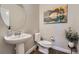 Cozy powder room featuring a pedestal sink, modern fixtures, and tasteful decor at 9574 Keystone Trl, Parker, CO 80134