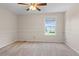 Bright bedroom featuring neutral walls, carpet flooring, and a ceiling fan at 10814 Bayfield Way, Parker, CO 80138