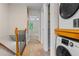 Hallway with laundry closet, wooden railing, and carpet flooring at 10814 Bayfield Way, Parker, CO 80138