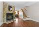 Open living room featuring a stone fireplace, hardwood floors and staircase at 10814 Bayfield Way, Parker, CO 80138