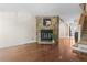 Open living room featuring a stone fireplace, hardwood floors and staircase at 10814 Bayfield Way, Parker, CO 80138