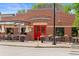 Red-brick Parker Garage, a local eatery, featuring outdoor seating and flower-filled window boxes at 10814 Bayfield Way, Parker, CO 80138