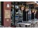 Restaurant's outdoor patio with hanging plants and comfortable seating at 3330 E 4Th Ave, Denver, CO 80206