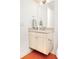 Bathroom with a floating vanity, a large mirror, and bright lighting above red tile floor at 99 S Albion St, Denver, CO 80246