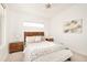 Bright bedroom with a wooden headboard, ceiling fan, neutral decor, and carpet flooring at 99 S Albion St, Denver, CO 80246