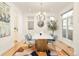 Dining room with modern chandelier, colorful rug, and a marble-top dining table at 99 S Albion St, Denver, CO 80246