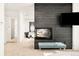 Cozy fireplace in the main bedroom with a tufted bench and a view of the gym equipment in the background at 99 S Albion St, Denver, CO 80246