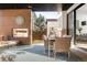 Covered patio featuring a brick fireplace, comfortable seating, and a backyard view at 99 S Albion St, Denver, CO 80246