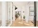 Bright foyer with hardwood floors, modern lighting, and a clear view of the staircase at 99 S Albion St, Denver, CO 80246