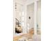 Hallway featuring hardwood floors, modern design, and access to multiple rooms at 99 S Albion St, Denver, CO 80246