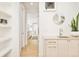 Bright hallway with hardwood floors, built-in shelves, and a view of the kitchen at 99 S Albion St, Denver, CO 80246