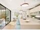 Bright, modern kitchen with an island, bar seating, and large sliding glass doors leading to an outdoor space at 99 S Albion St, Denver, CO 80246