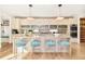 Modern kitchen with island seating, custom cabinetry, and designer lighting at 99 S Albion St, Denver, CO 80246