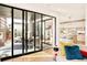 Open-concept living room with sliding doors to the patio and a view of the kitchen at 99 S Albion St, Denver, CO 80246