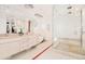 Bright main bathroom with a double vanity, a shower, and a closet at 99 S Albion St, Denver, CO 80246