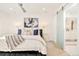 Bright main bedroom with a bed, a nightstand, and a sliding glass door leading to the bathroom at 99 S Albion St, Denver, CO 80246