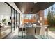 Covered patio featuring comfortable seating, an outdoor dining area, and a cozy fireplace at 99 S Albion St, Denver, CO 80246