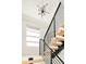 Modern staircase with metal railings, wooden steps, and a large chandelier at 99 S Albion St, Denver, CO 80246