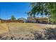 Spacious backyard featuring a covered patio and ample room for outdoor activities at 5183 Durham Ct, Denver, CO 80239