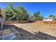 Extensive backyard with mature trees and a wooden fence offering privacy at 5183 Durham Ct, Denver, CO 80239