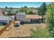 View of fenced backyard with brown lawn, covered patio, and solar panels on roof at 5183 Durham Ct, Denver, CO 80239