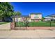Attractive home with a lush front lawn, decorative fence, and mature landscaping at 5183 Durham Ct, Denver, CO 80239