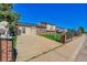 Attractive home with a lush front lawn, decorative fence, and mature landscaping at 5183 Durham Ct, Denver, CO 80239