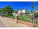 Attractive home with a lush front lawn, decorative fence, and mature landscaping at 5183 Durham Ct, Denver, CO 80239