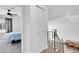 Bright hallway leading to a bedroom and overlooking the dining area with staircase at 5183 Durham Ct, Denver, CO 80239