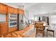 Spacious kitchen with stainless steel appliances, wooden cabinetry, and adjacent dining area at 5183 Durham Ct, Denver, CO 80239