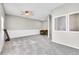 Spacious bonus room with neutral carpet, a ceiling fan, and large windows offering plenty of natural light at 5183 Durham Ct, Denver, CO 80239