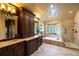 Luxurious bathroom with custom wood cabinets, soaking tub, walk-in shower and beautiful natural light from the skylight at 9 Roder Gate Ln, Castle Pines, CO 80108