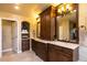 Spacious bathroom with custom wood cabinets, marble countertop, double vanity, and an ornate display shelf at 9 Roder Gate Ln, Castle Pines, CO 80108