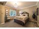 Neutral bedroom with chandelier lighting, decorative wall art and an elegantly decorated bed at 9 Roder Gate Ln, Castle Pines, CO 80108