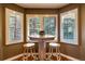 Cozy breakfast nook with a table and chairs near windows with shutters at 9 Roder Gate Ln, Castle Pines, CO 80108