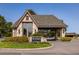 Community entrance featuring a stone building with a porte cochere and lush landscaping for a welcoming feel at 9 Roder Gate Ln, Castle Pines, CO 80108