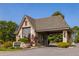 Charming stone-clad entrance building with a covered drive-through and well-maintained landscaping at 9 Roder Gate Ln, Castle Pines, CO 80108