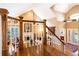 Inviting foyer with high ceilings, hardwood floors, staircase, and a view of the living room and fireplace at 9 Roder Gate Ln, Castle Pines, CO 80108
