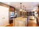 Bright open kitchen featuring a large island, granite countertops, and modern appliances at 9 Roder Gate Ln, Castle Pines, CO 80108